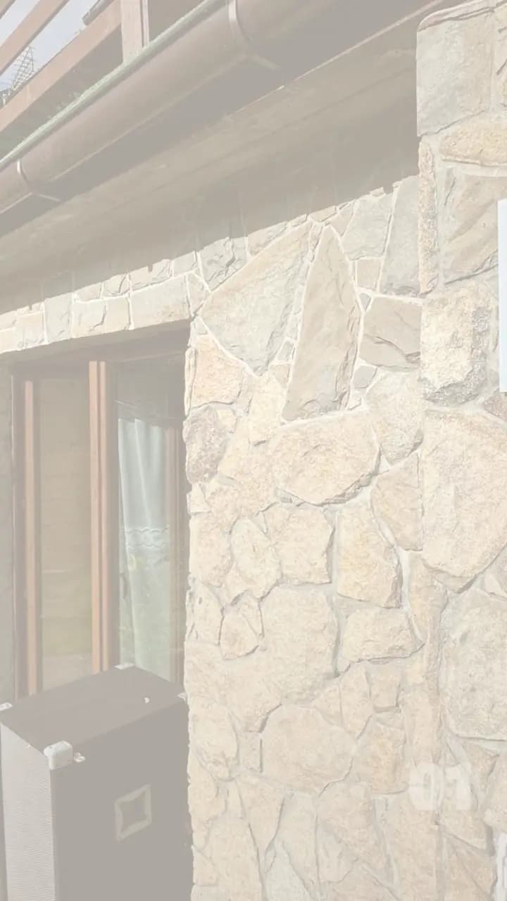 Reel frame: a stone facade and the terrace door